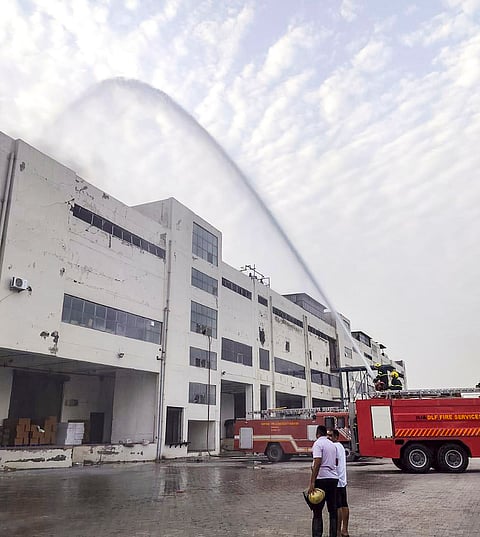 Firemen douse a fire at a warehouse at Jhund Sarai area, in Gurugram district, Haryana.