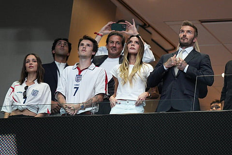 Former England soccer player David Beckham, right, stands before the start of the World Cup semifinal soccer match