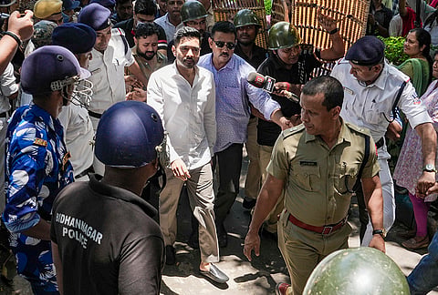 TMC leader Abhishek Banerjee being escorted by police and security personnel as he arrives to give his voice sample before a magistrate in connection with an investigation into his alleged intimidatory speech during the West Bengal assembly election campaign, at the Bidhannagar court, in Kolkata.
