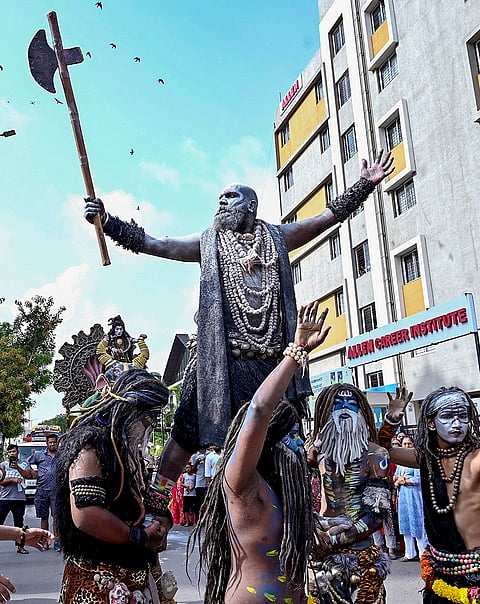 Artists dressed as Lord Shiva and other mythological characters perform during the Jagannath Rath Yatra procession, in Rajkot, Gujarat.