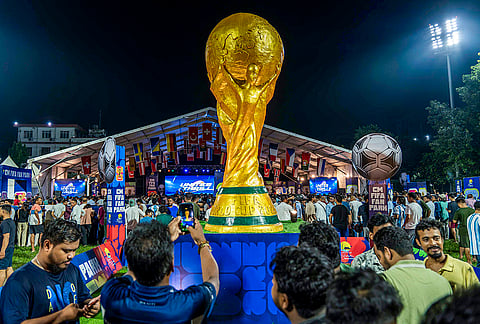 An installation of the replica of the trophy of FIFA World Cup 2026 placed at CM FIFA Fan Park during the public screening of Argentina vs England semi-final match of the international football tournament, in Guwahati, Assam.