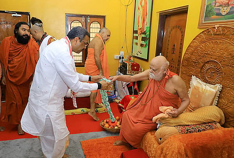 Union Education Minister Dharmendra Pradhan greets spiritual leader Swami Nischalananda Saraswati during a visit to the Govardhan Math on the occasion of the Rath Yatra festival, in Puri, Odisha. 