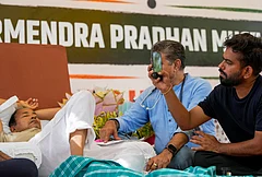 Cockroach Janata Party (CJP) founder Abhijeet Dipke, right, looks on as a medical professional attends climate activist Sonam Wangchuk, left, during a protest demanding Union Education Minister Dharmendra Pradhan's resignation over alleged irregularities in the NEET examination, at the Jantar Mantar, in New Delhi. Wangchuk has been on an indefinite hunger strike for 18 days. - | Photo: PTI/Ravi Choudhary