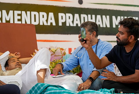 Cockroach Janata Party (CJP) founder Abhijeet Dipke, right, looks on as a medical professional attends climate activist Sonam Wangchuk, left, during a protest demanding Union Education Minister Dharmendra Pradhan's resignation over alleged irregularities in the NEET examination, at the Jantar Mantar, in New Delhi. Wangchuk has been on an indefinite hunger strike for 18 days. 
