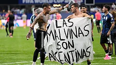Argentina's Giovani Lo Celso holds a banner with the words "The Malvinas are Argentine", referring to the Falkland Islands, while teammate Argentina's Nicolas Otamendi gestures to him, at the end of the World Cup semifinal soccer match between England and Argentina in Atlanta, Wednesday, July 15, 2026 - (AP Photo/Rebecca Blackwell)