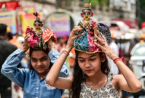 People carry miniature idols of Lord Krishna as they take part in the annual Jagannath Rath Yatra, in Prayagraj, Uttar Pradesh.