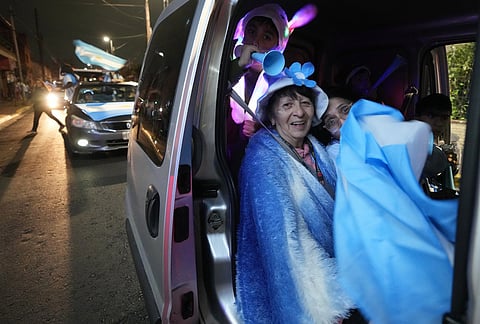 A family celebrates Argentina's victory over England in a World Cup semifinal soccer match while driving through Buenos Aires, Argentina, Wednesday, July 15, 2026. 