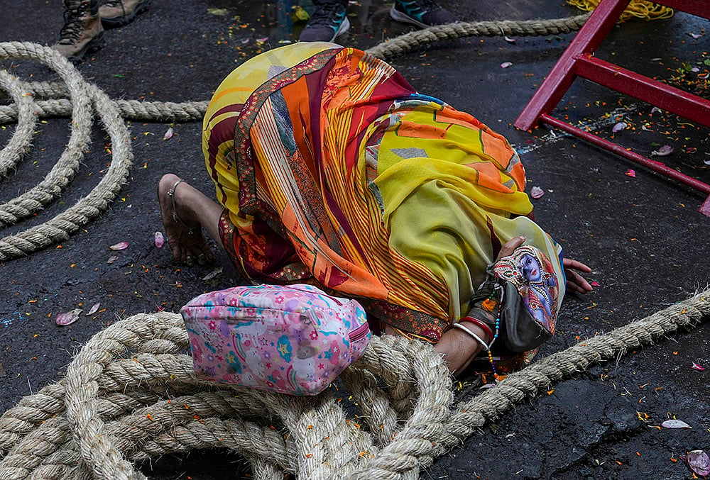 A woman offers prayers during the annual Rath Yatra festival celebration organised by ISKCON, in Kolkata, West Bengal, Thursday, July 16, 2026. 