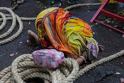 A woman offers prayers during the annual Rath Yatra festival celebration organised by ISKCON, in Kolkata, West Bengal, Thursday, July 16, 2026. 