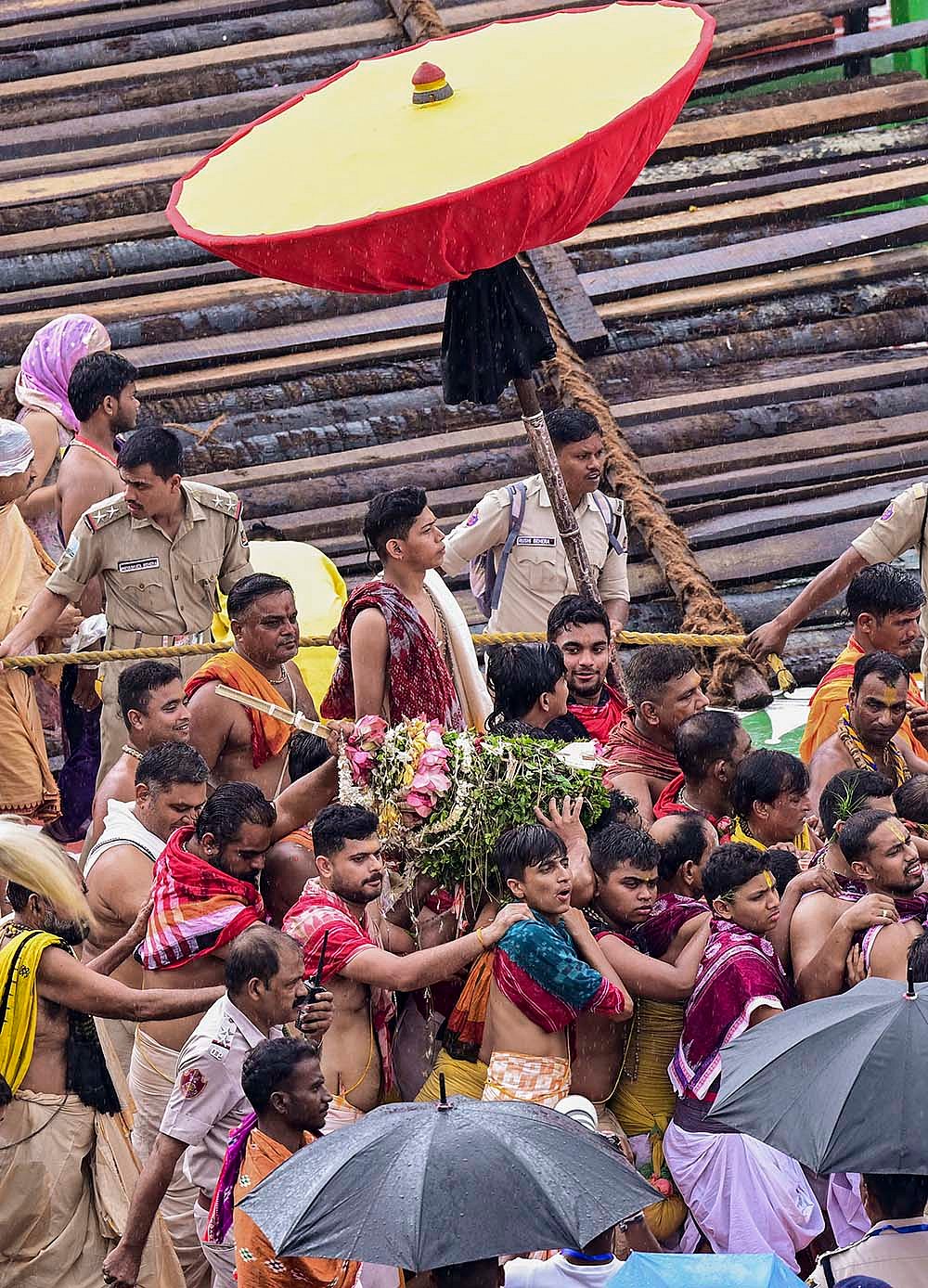 Priests and servitors perform the Pahandi ritual, carrying the deities Lord Jagannath, Lord Balabhadra and Goddess Subhadra from the temple sanctum to their chariots, during the annual Rath Yatra festival, in Puri, Odisha.