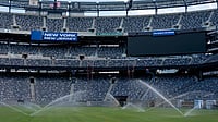 | Photo: AP/Yuki Iwamura : Sprinkler water grass during the pitch installation for FIFA World Cup 2026 at NYNJ Stadium in East Rutherford, New Jersey. 