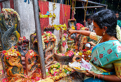 A woman performs rituals during the Tamil month of 'Aadi', at Amman Temple, in Chennai. 'Velli Kizhamai' or Fridays in the month of 'Aadi' are considered auspicious for worshiping Hindu deities, especially the various incarnations of Shakti. Devotees also worship 'Nagas', snakes, on this day. 