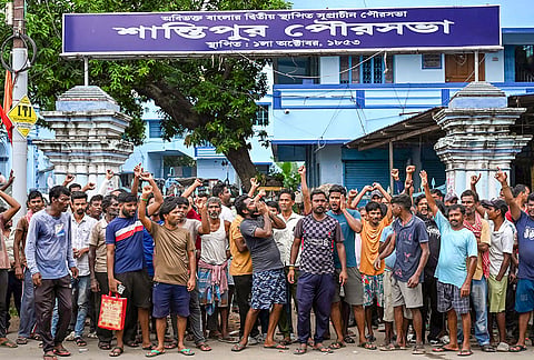 Santipur municipality workers stage a demonstration in front of the civic body office demanding a hike in their daily wages and equal pay status for similar jobs, at Santipur, in Nadia district, West Bengal.