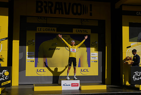 Slovenia's Tadej Pogacar, wearing the overall leader's yellow jersey, celebrates on the podium after winning the tenth stage of the Tour de France cycling race with start in Aurillac and finish in Le Lioran, France, Tuesday, July 14, 2026.