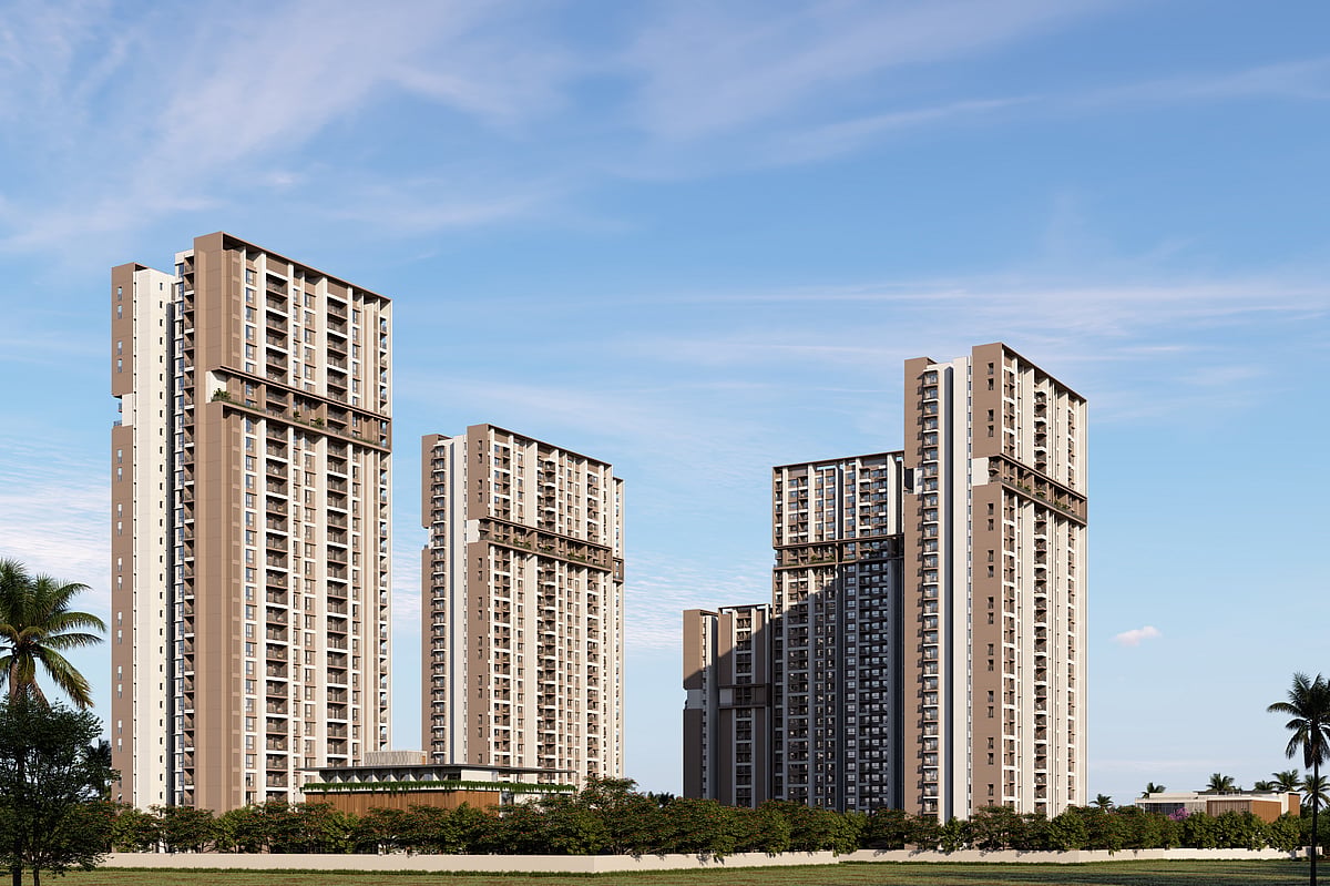 Modern high-rise residential apartment towers with green landscaping under a clear sky