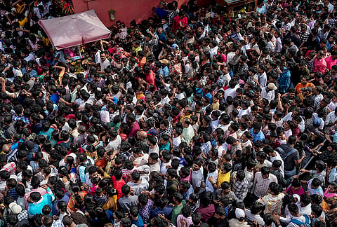 Devotees gather around the chariot carrying the idols of Lord Jagannath, Lord Balabhadra and Goddess Subhadra during the annual Rath Yatra procession, in Bengaluru, Karnataka, Thursday, July 16, 2026. 