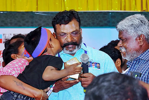 Madurai: Viduthalai Chiruthaigal Katchi (VCK) leader Thirumavalavan being embraced by a child during a party meeting, in Madurai, Tamil Nadu.