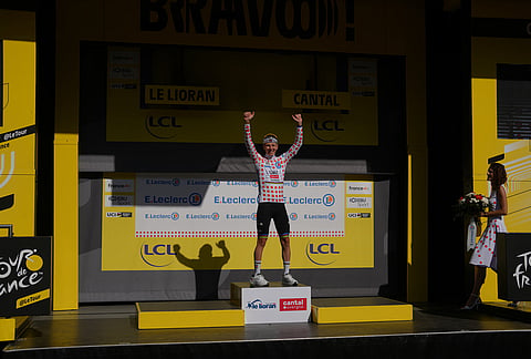 Slovenia's Tadej Pogacar, wearing the best climber's dotted jersey, celebrates on the podium after winning the tenth stage of the Tour de France cycling race with start in Aurillac and finish in Le Lioran, France, Tuesday, July 14, 2026. 