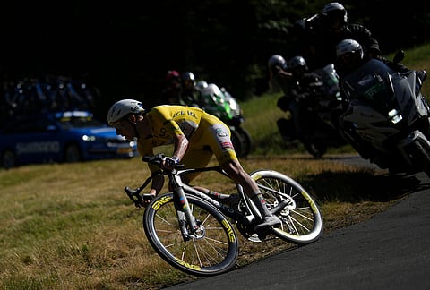 Slovenia's Tadej Pogacar, wearing the overall leader's yellow jersey, speeds towards the final stage of the tenth stage of the Tour de France cycling race with start in Aurillac and finish in Le Lioran, France, Tuesday, July 14, 2026.  