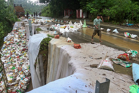 Labourers reinforce a damaged stretch of National Highway-8 with sandbags after heavy monsoon rains triggered severe erosion and road cave-ins, in Dhalai district of Tripura. Traffic has been restricted on the affected stretch as emergency restoration work continues on the highway, Tripura's primary road link to the rest of the country. 