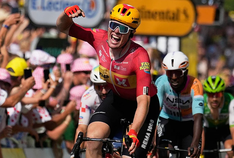 Norway's Soren Waerenskjold celebrates as he crosses the finish line to win the eleventh stage of the Tour de France cycling race with start in Vichy and finish in Nevers, France, Wednesday, July 15, 2026. - | Photo: AP/Mosa'ab Elshamy