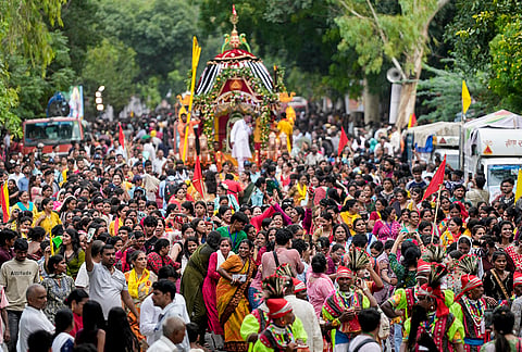 People take part in a procession of Lord Jagannath, Lord Balabadhra and Goddess Subadhra during the 59th annual Rath Yatra of Thyagraj Jagannath Temple, at Tyagraj Nagar, in New Delhi, Thursday, July 16, 2026. 