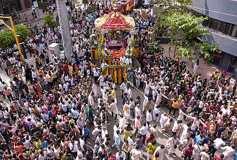 Devotees take part in a religious procession on the ‘Rath Yatra’ festival, on Varachha Road in Surat, Thursday, July 16, 2026. 