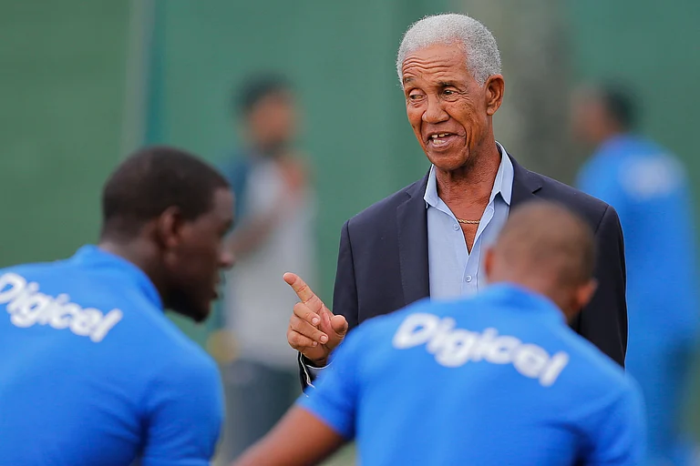 West Indies cricket great Garfield Sobers, right, chats with West Indies team members during a training session ahead of their second test cricket match against Sri Lanka in Colombo, Sri Lanka, Oct. 21, 2015. - AP/File-Eranga Jayawardena