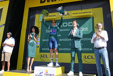 Denmark's Mads Pedersen, wearing the best sprinter's green jersey, celebrates on the podium after the eleventh stage of the Tour de France cycling race with start in Vichy and finish in Nevers, France, Wednesday, July 15, 2026. 