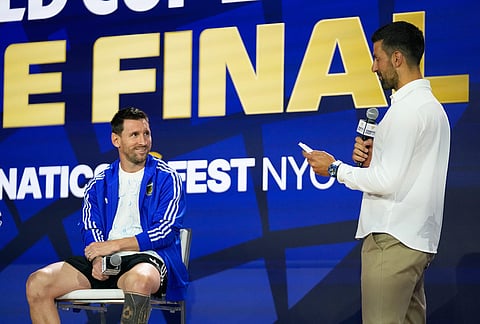 Argentina's Lionel Messi listens to tennis player Novak Djokovic during a news conference ahead of the World Cup final soccer match between Spain and Argentina in New York, Friday, July 17, 2026.