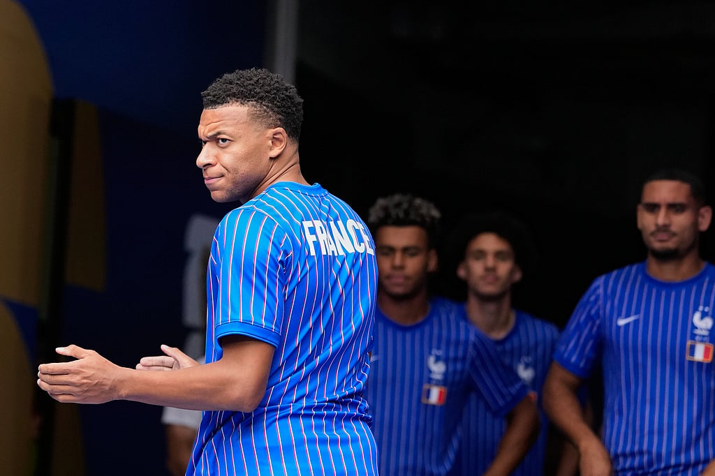 Frances Kylian Mbappe prepares to lead the team onto the pitch for warmups before the World Cup third-place playoff soccer match between France and England in Miami Gardens