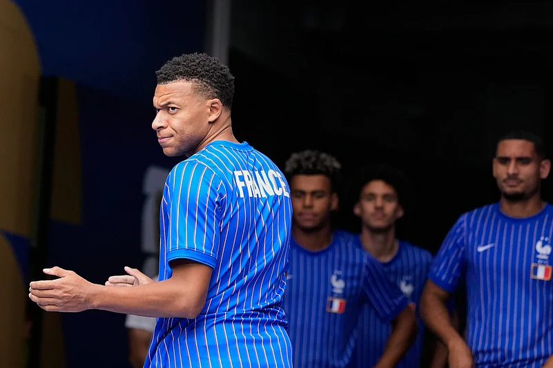Frances Kylian Mbappe prepares to lead the team onto the pitch for warmups before the World Cup third-place playoff soccer match between France and England in Miami Gardens