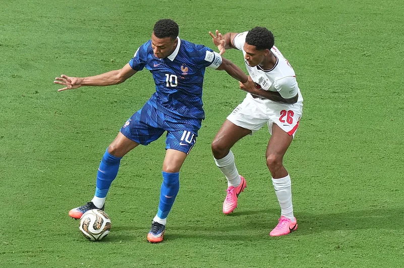 Frances Kylian Mbappe (10) moves the ball past Englands Jarell Quansah (26) during the World Cup third-place playoff soccer match between France and England in Miami Gardens