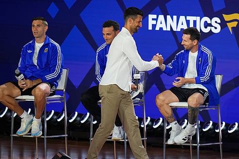 Tennis player Novak Djokovic greets Argentina's Lionel Messi as goalkeeper Emiliano Martinez, left, and head coach Lionel Scaloni look on during a news conference ahead of the World Cup final soccer match between Spain and Argentina in New York, Friday, July 17, 2026. 
