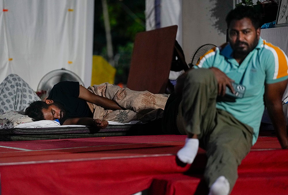 Cockroach Janata Party (CJP) founder Abhijeet Dipke rests at Jantar Mantar before activist Sonam Wangchuk, unseen, who has been on an indefinite hunger strike for 21 days, is shifted to a hospital for medical care, in New Delhi, early Saturday, July 18, 2026. 