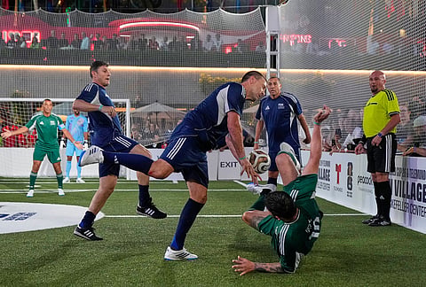Former soccer players John Terry, center, and Andre-Pierre Gignac battle for the ball during a FIFA legends soccer match being played two days ahead of the World Cup final in New York, Friday, July 17, 2026. 