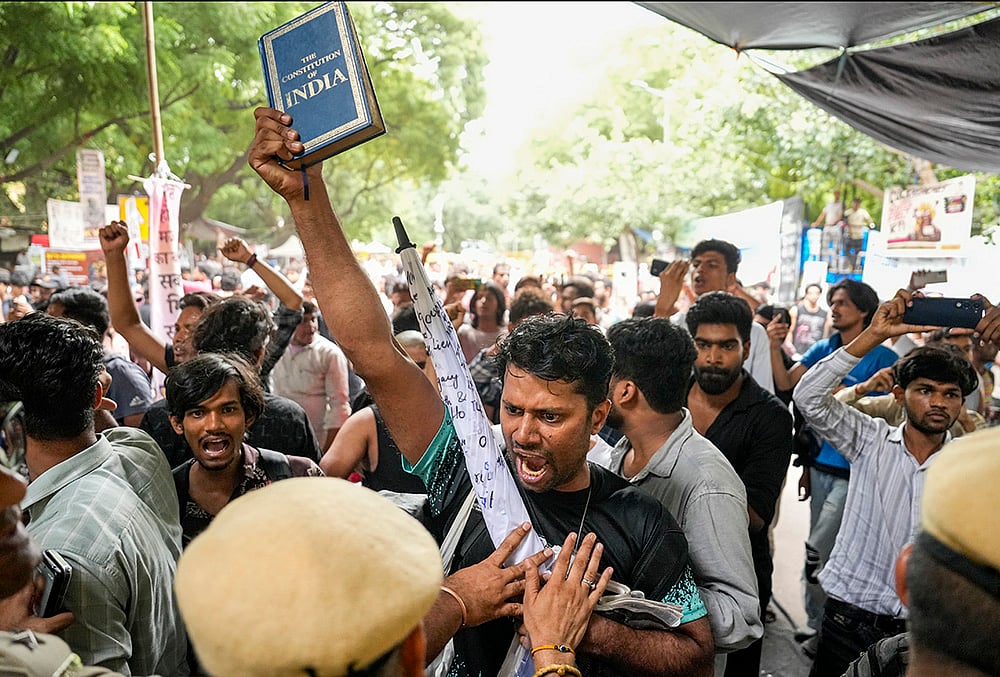 Security personnel detain supporters of the Cockroach Janata Party (CJP) as they raise slogans after activist Sonam Wangchuk, unseen, who has been on an indefinite hunger strike for 21 days, is shifted to a hospital from Jantar Mantar, in New Delhi, Saturday, July 18, 2026. 