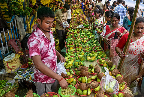 A vendor arranges fruits, used as offerings, to observe 'Bipattarini Puja', at Kalighat, in Kolkata, West Bengal. It is celebrated on the first Tuesday or Saturday in the Hindu month of Ashadha (Shukla Paksha), falling between Rath Yatra and Bahuda Yatra. 
