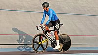 insta/harshveersekhon : Harshveer Singh Sekhon is seen riding his track bicycle on a velodrome during a training or competition session, wearing a blue long-sleeved skinsuit, black aerodynamic helmet and race number 307. Captured on the steeply banked track, the image highlights the aerodynamic position and specialized equipment used in elite track cycling, including a disc rear wheel