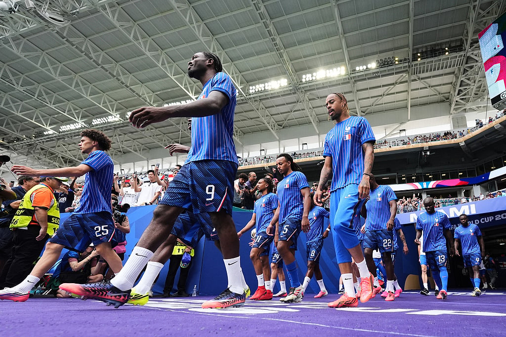French players walk onto the pitch for warmups for the World Cup third-place playoff soccer match between France and England in Miami Garden