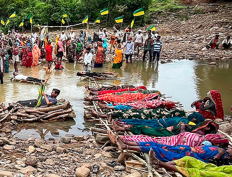 Farmers and tribal people displaced by the Ken-Betwa River Linking Project stage a Jal Satyagraha and Chita Andolan, demanding better compensation and rehabilitation, in Chhatarpur, Madhya Pradesh, Monday, July 13, 2026. 