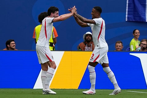 England's Ezri Konsa, right, is congratulated by Declan Rice after scoring his side's 2nd goal during the World Cup third-place playoff soccer match between France and England in Miami Gardens
