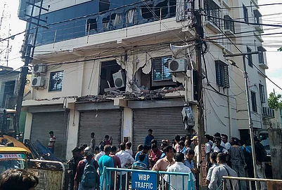 | Photo: PTI : People gather amid the demolition of the party office of Trinamool Congress MP Abhishek Banerjee after it was allegedly found to be constructed without an approved building plan and in violation of applicable rules, in Amtala, South 24 Parganas district, West Bengal.