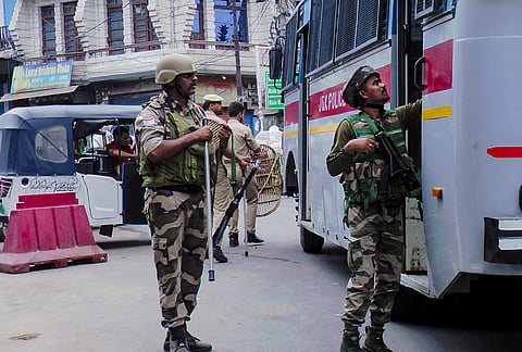 Security personnel checks a vehicle following a 'Bandh' called by the Markaz-e-Seerat committee, in Doda, Jammu and Kashmir.