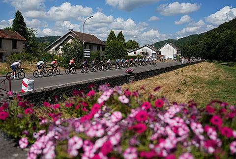 The pack rides during the thirteenth stage of the Tour de France cycling race with start in Dole and finish in Belfort, France, Friday, July 17, 2026. 