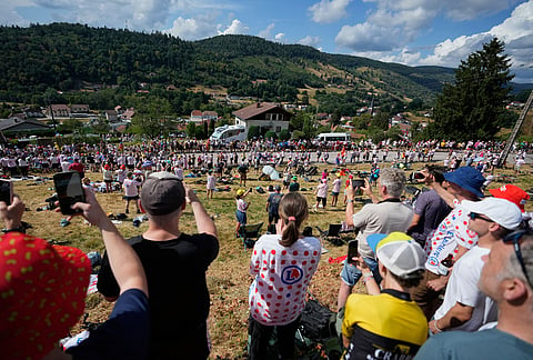 Spectators wait for the riders to pass during the thirteenth stage of the Tour de France cycling race with start in Dole and finish in Belfort, France, Friday, July 17, 2026.