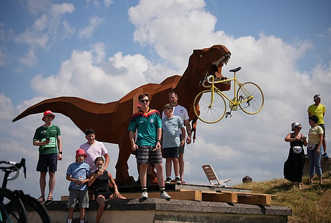 Spectators wait for the riders to pass during the thirteenth stage of the Tour de France cycling race with start in Dole and finish in Belfort, France, Friday, July 17, 2026. 