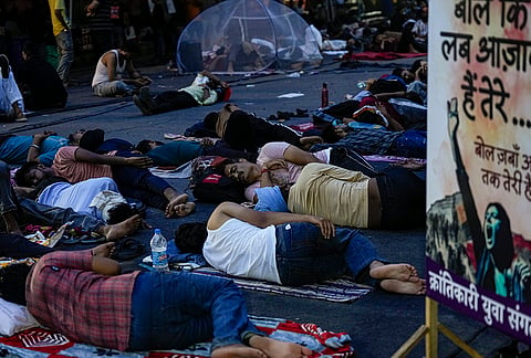 Supporters of the Cockroach Janata Party (CJP) rest at Jantar Mantar before activist Sonam Wangchuk, unseen, who has been on an indefinite hunger strike for 21 days, is shifted to a hospital for medical care, in New Delhi, early Saturday, July 18, 2026. 