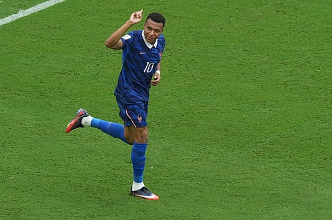 France's Kylian Mbappe (10) celebrates scoring their first goal during the World Cup third-place playoff soccer match between France and England in Miami Gardens