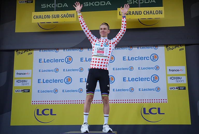 Slovenia's Tadej Pogacar, wearing the best climber's dotted jersey celebrates on the podium after the twelfth stage of the Tour de France cycling race with start in Circuit Nevers Magny-Cours and finish in Chalon-sur-Saone, France, Thursday, July 16, 2026. - | Photo: AP/Thibault Camus